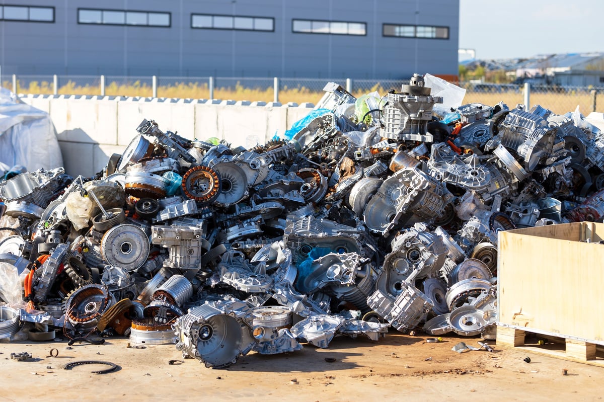 Large scrap metal pile of automotive components at a recycling facility awaiting processing